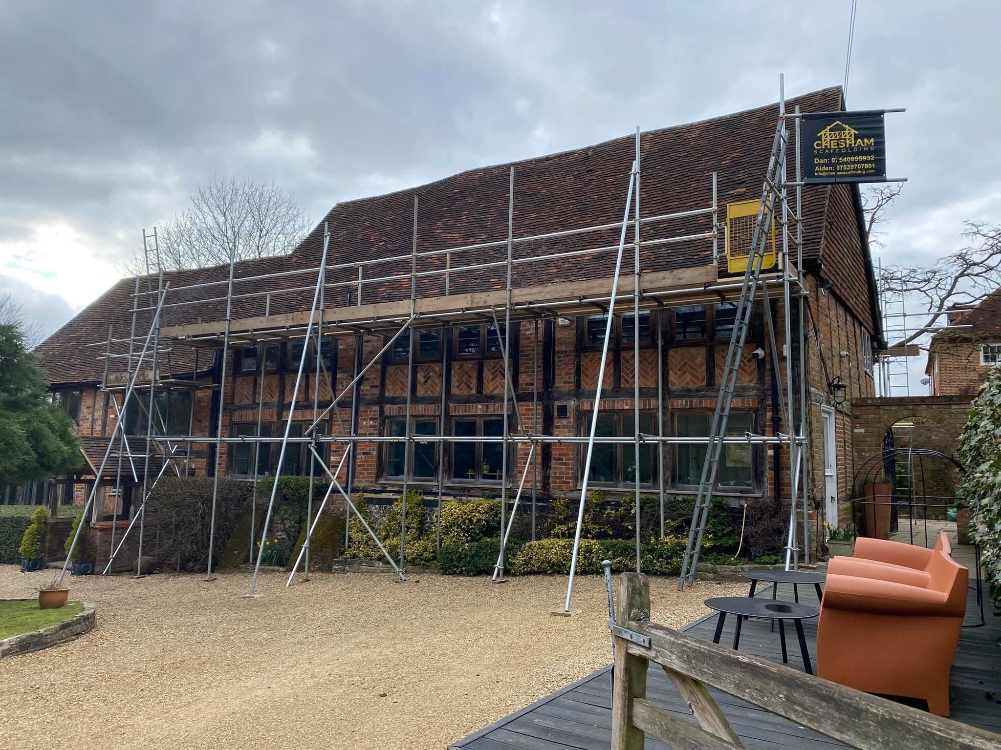 Timber-framed barn with a long run of scaffold