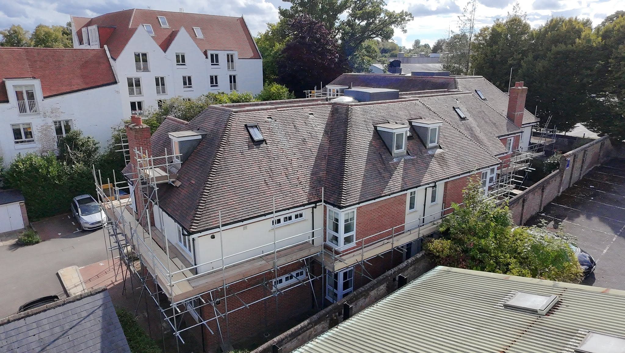 Drone view of a large house with scaffold on two elevations
