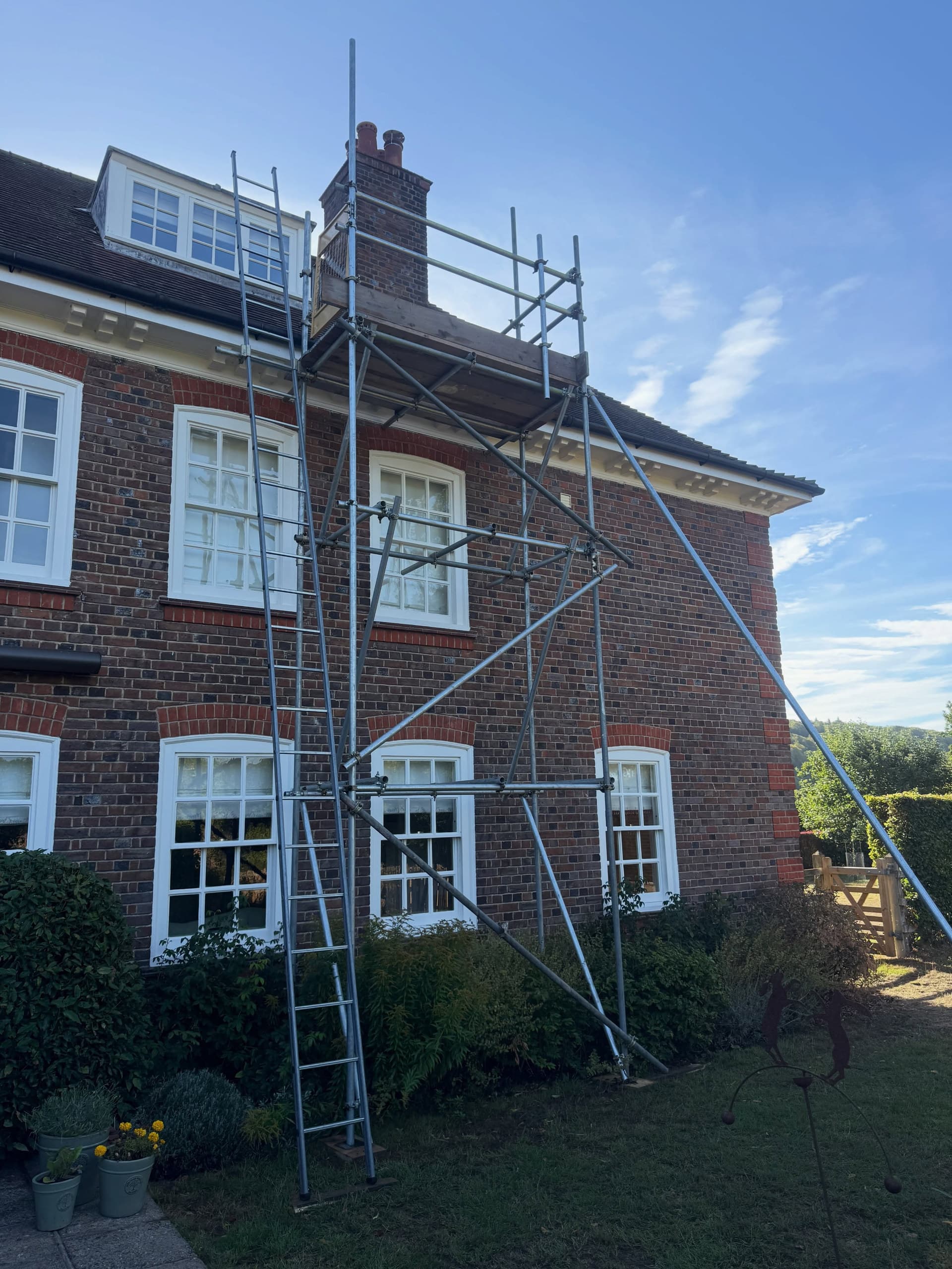 Chimney access scaffold and ladder up the side of a Georgian brick house