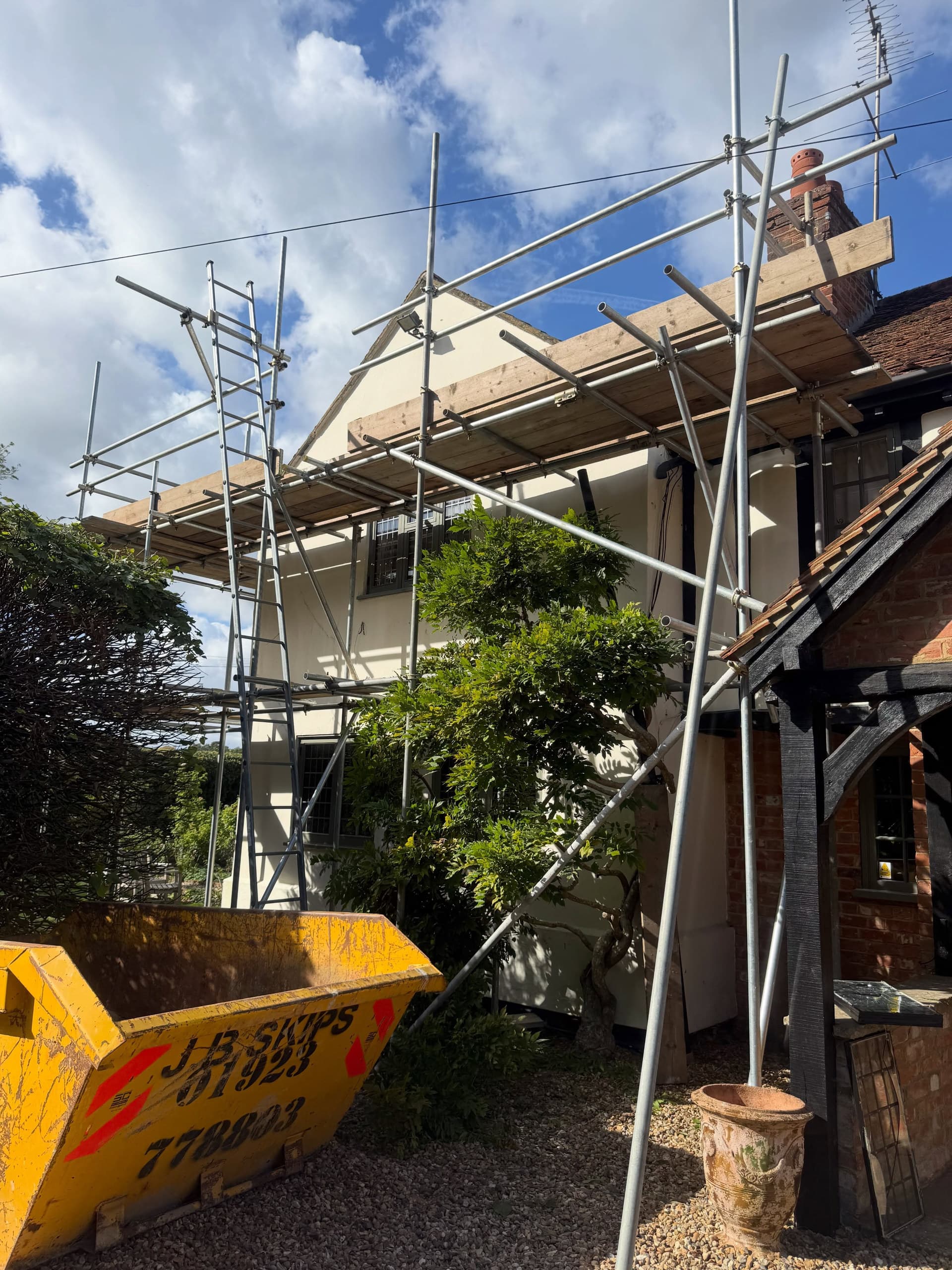 Mock-Tudor house with scaffold up to the roof