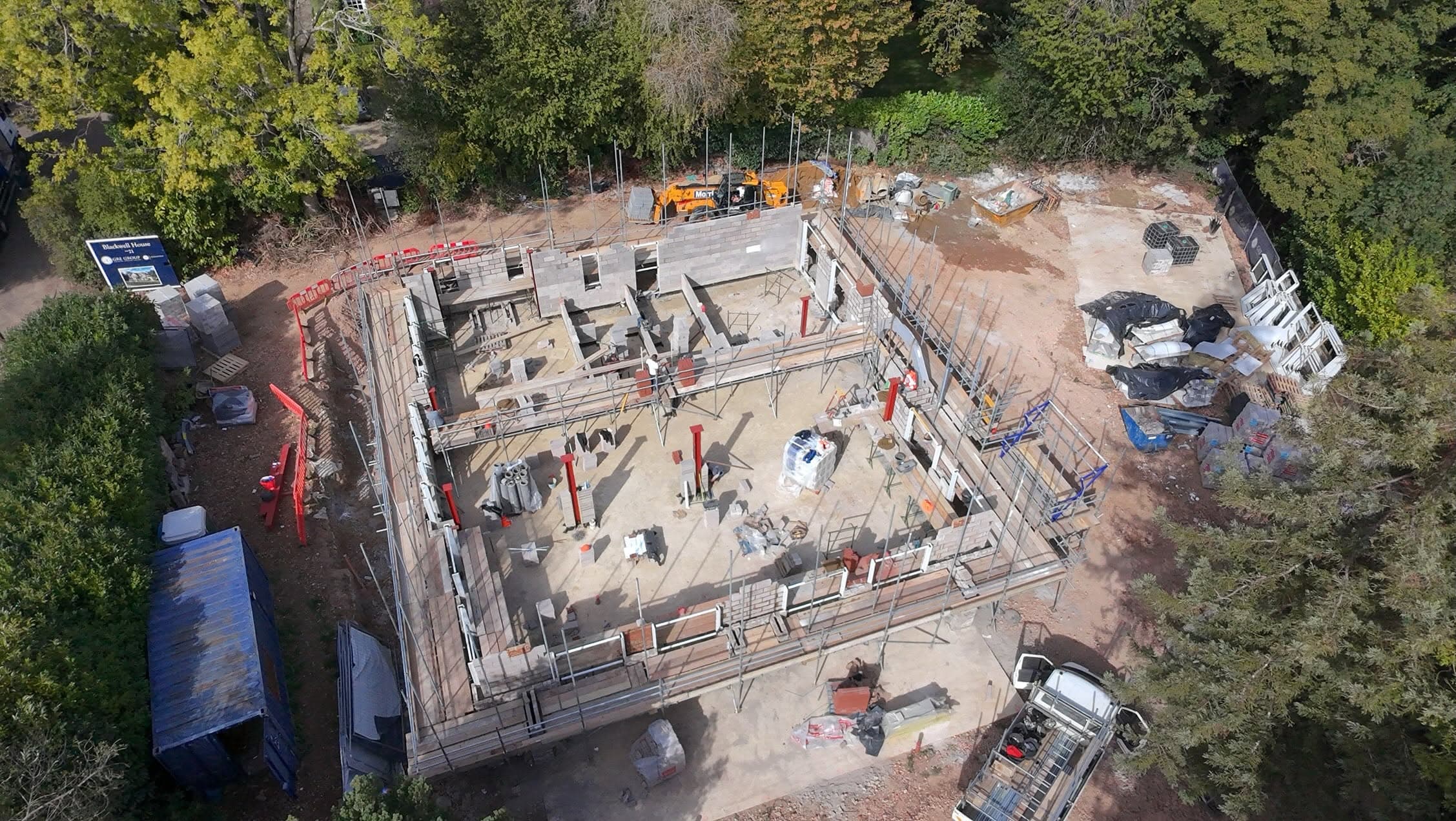 Drone view of a new-build footprint with scaffold round the walls