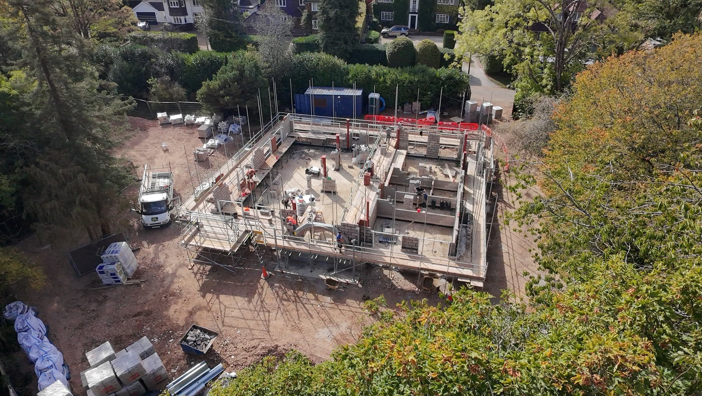 Drone view of a new-build plot with scaffold around the walls