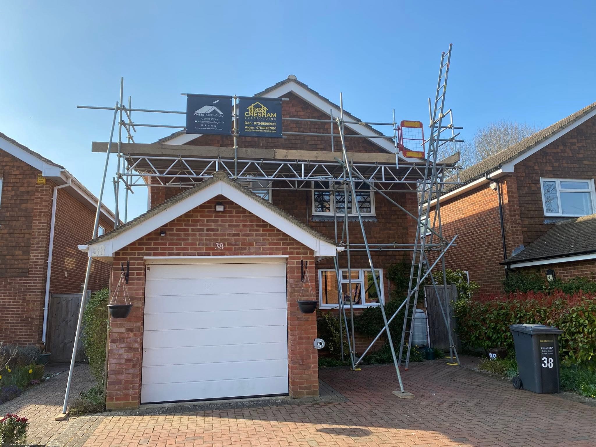 Detached house with scaffold bridging over the garage