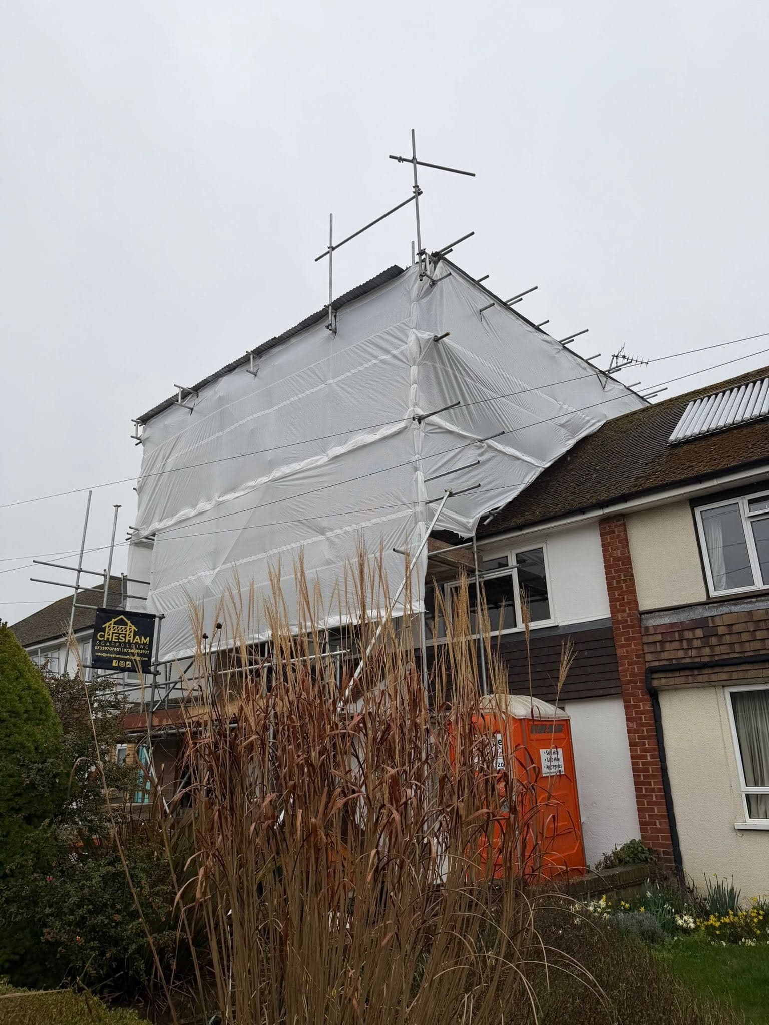 Sheeted scaffold over a gable end
